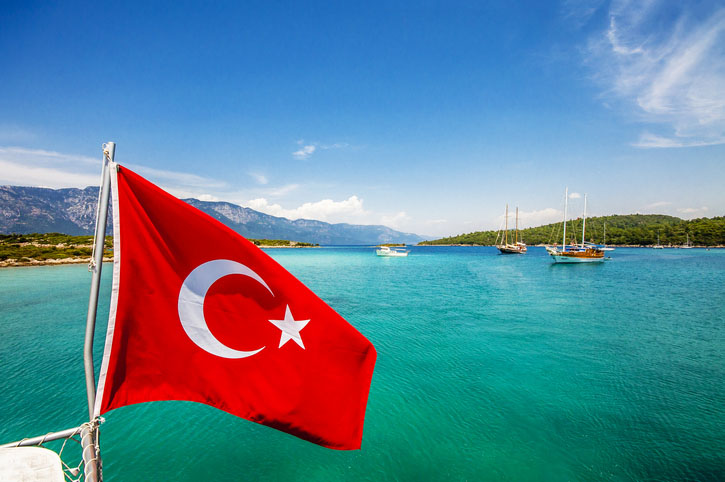 The Turkish flag flies over the water