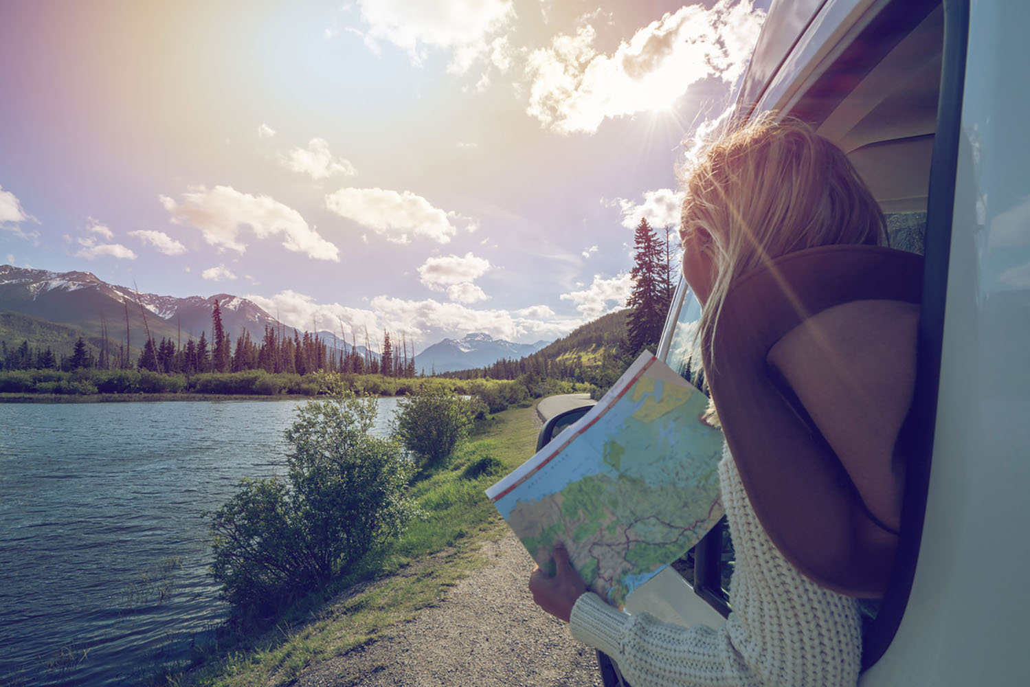 A woman looks at a map while traveling