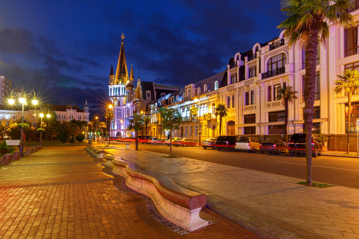 A city square illuminated at night in Batumi. Georgia