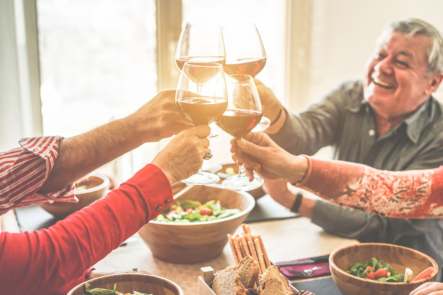 Friends toast with wine over dinner