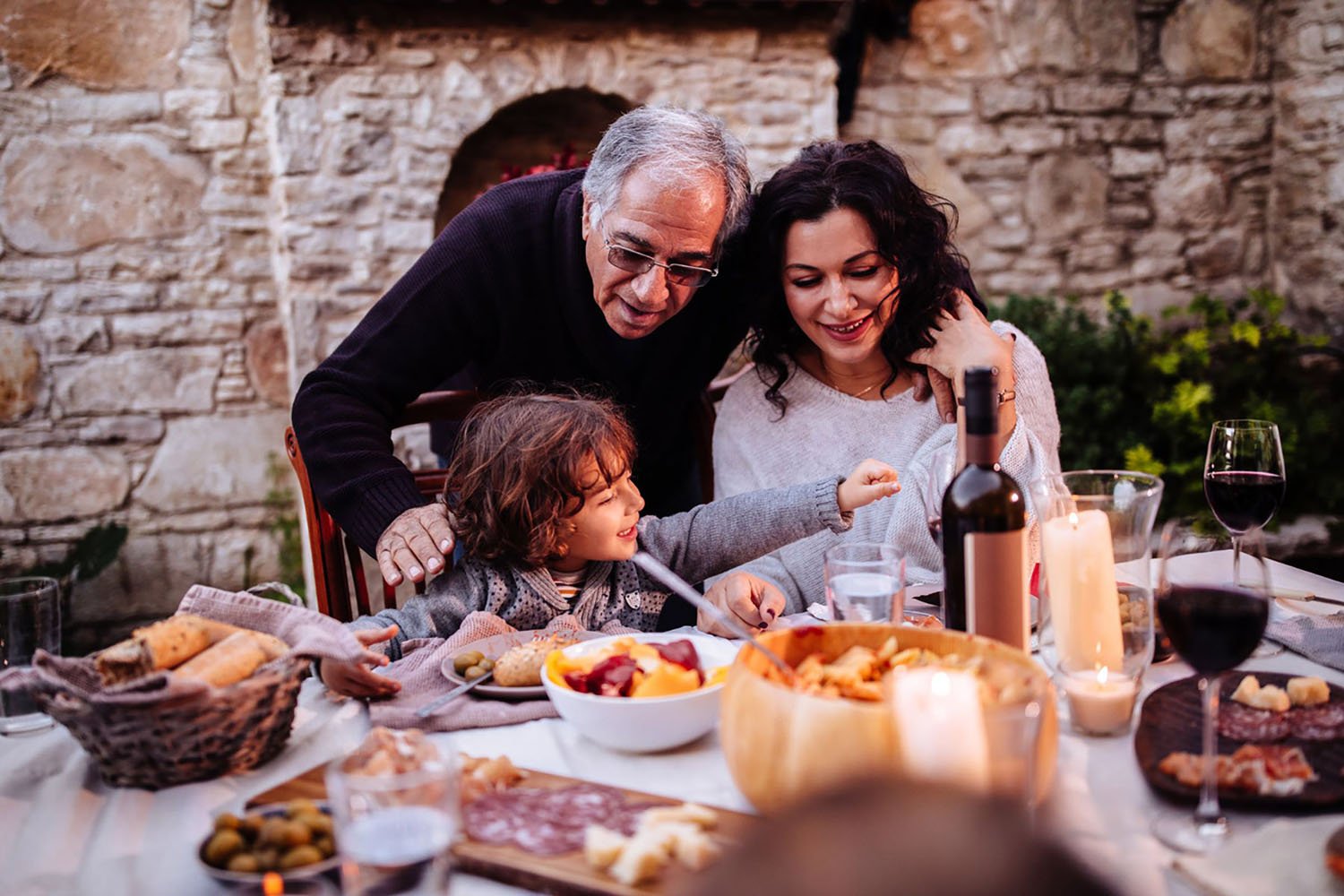 A family having Italian lunch at traditional rustic restaurant in Italian village