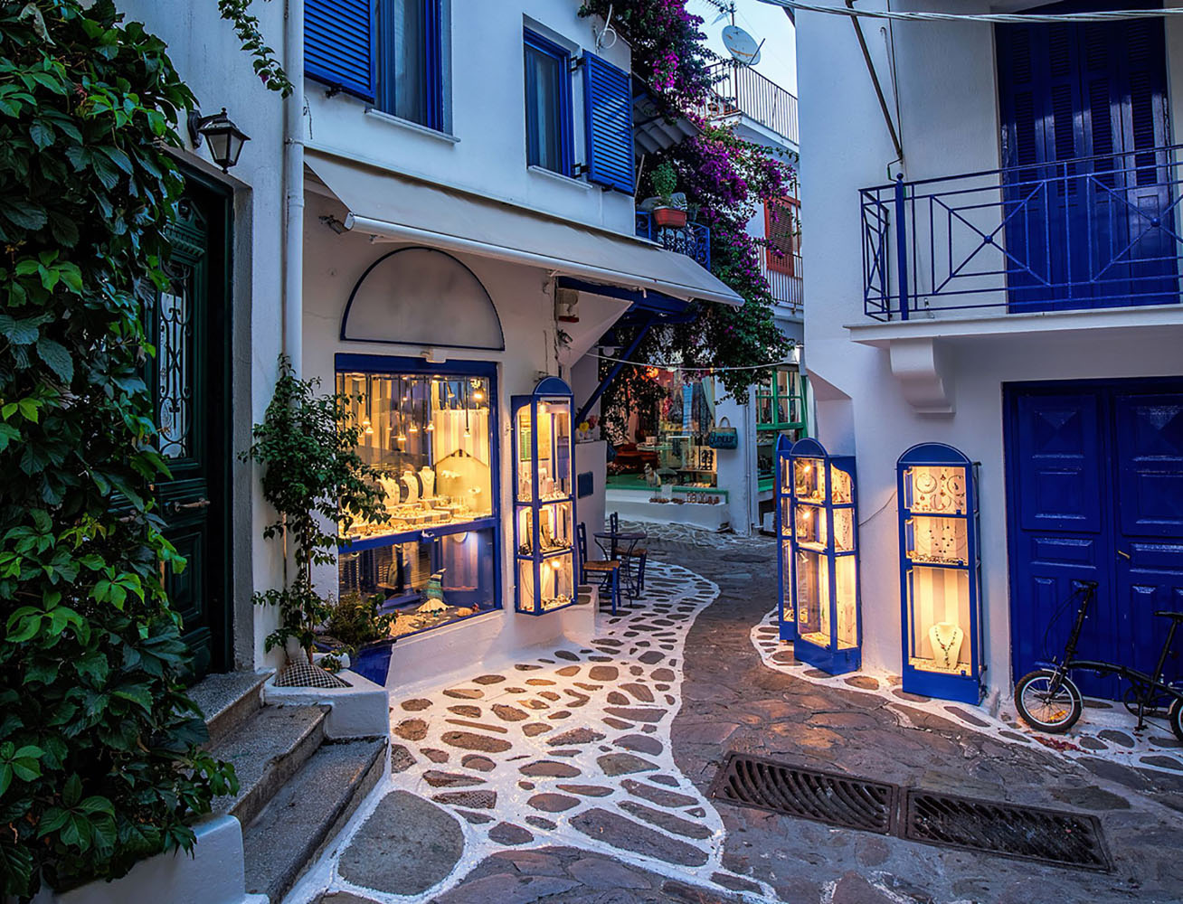 A narrow alley with cobblestone paving in Skiathos, Greece