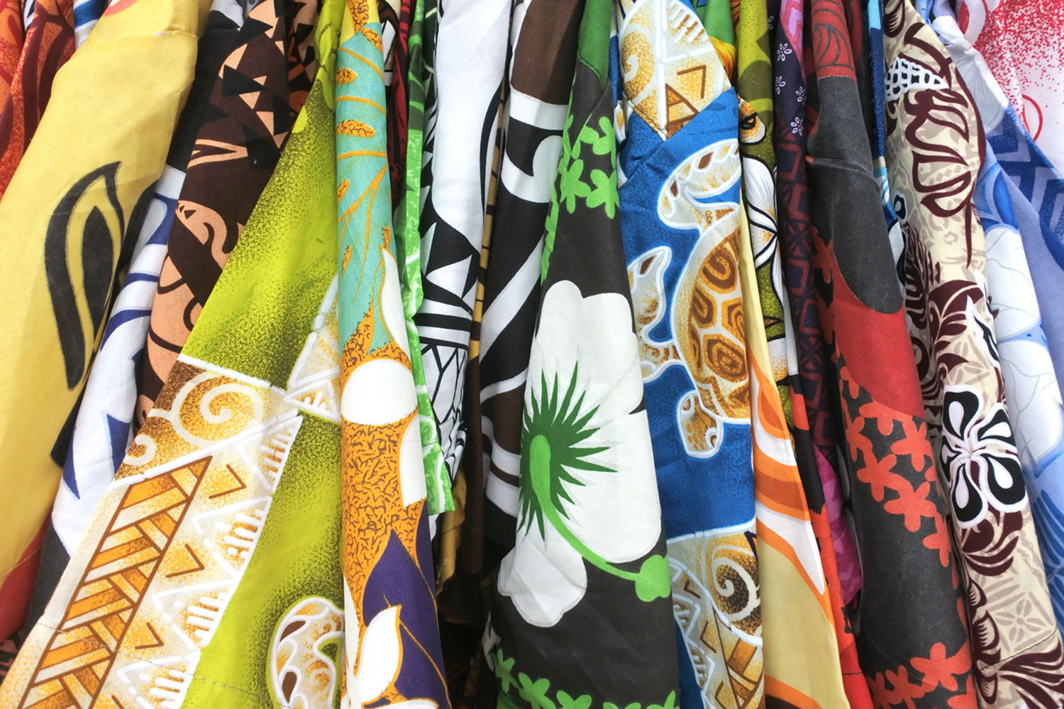 Colorful shirts with island patterns for sale in a shopping distract