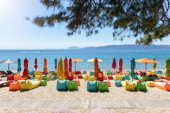 Umbrellas and lounge chairs on the beach in Skiathos, Greece