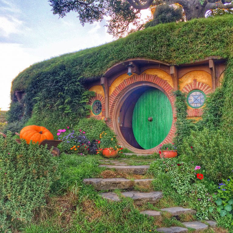 A hobbit house with a green door from the hobbiton movie set
