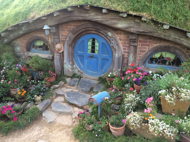 A hobbit house with a blue door from the hobbiton movie set
