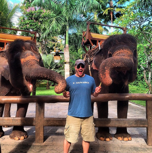 Lee Abbamonte in Bali with two elephants.