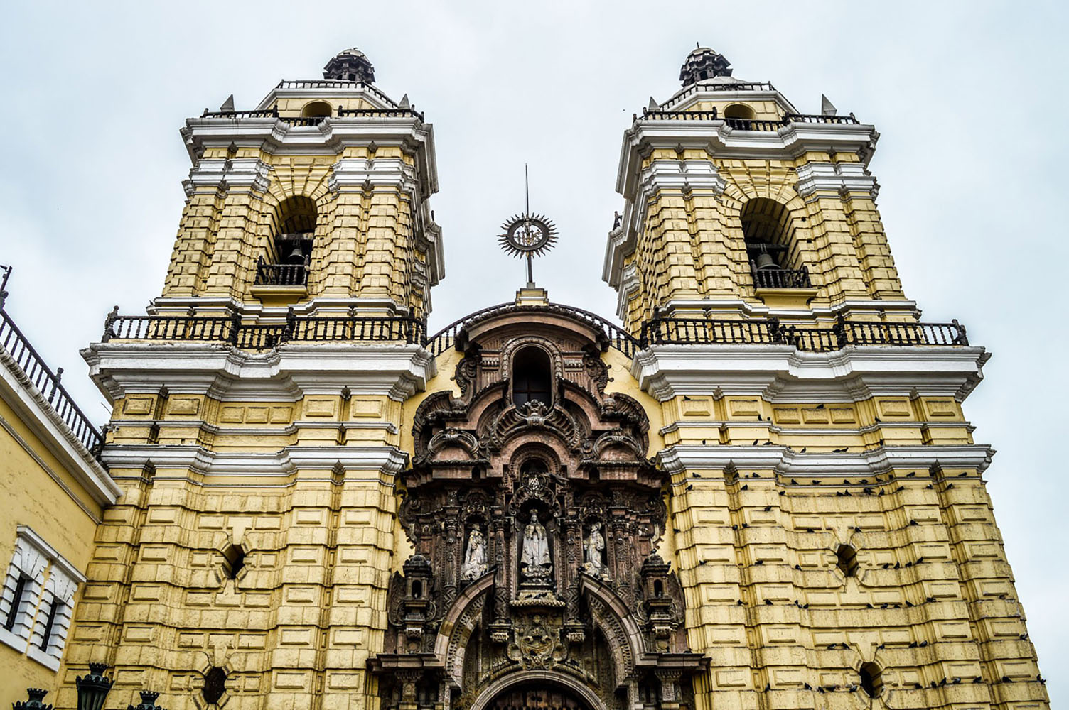 The yellow exterior of the Monasterio de San Francisco in Lima