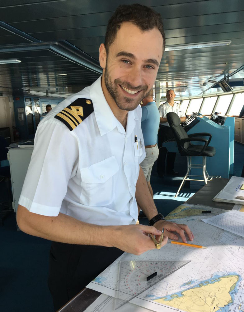 First Officer, Simone Patalano, plotting a cruise route on paper charts