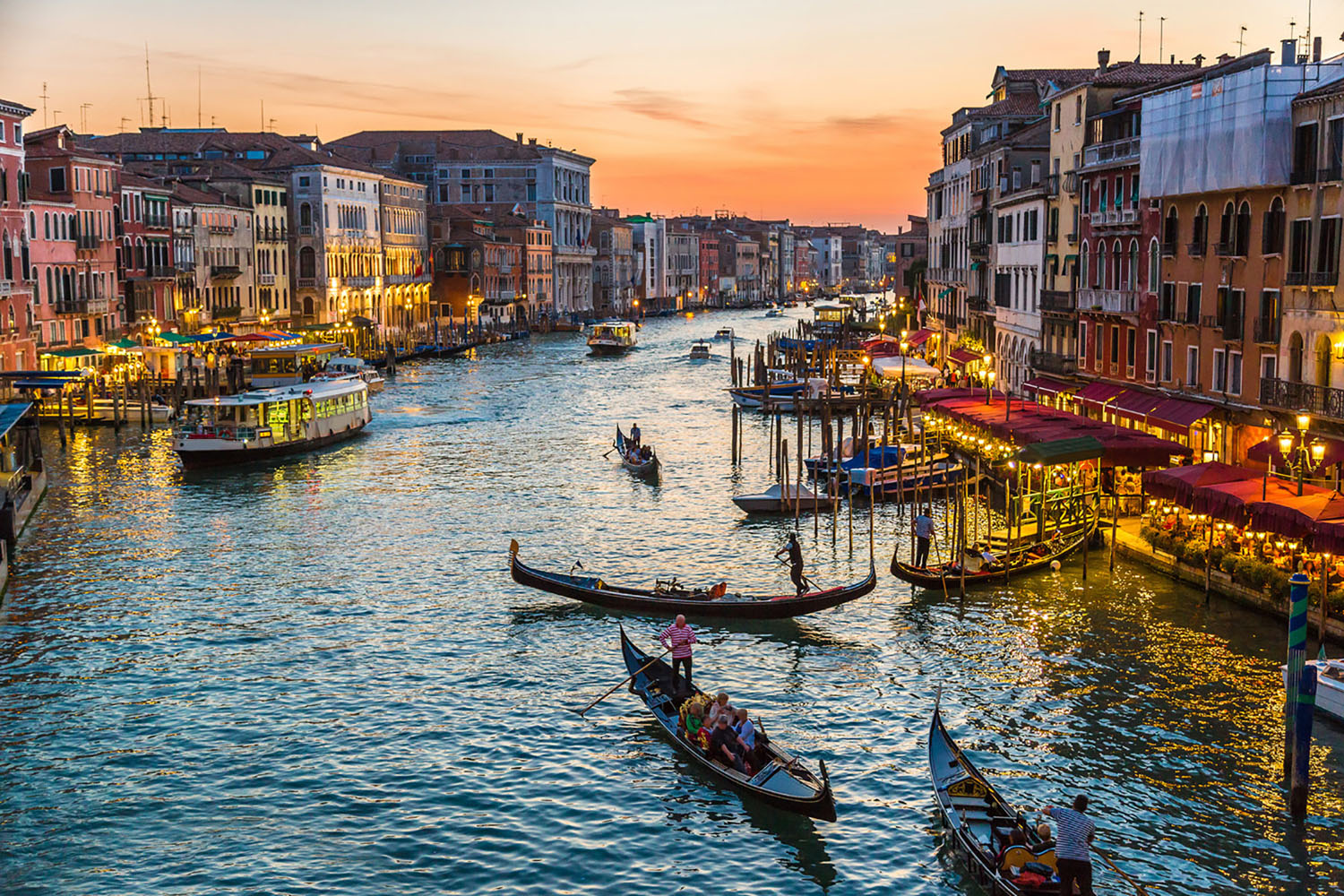 Gondolas in a Venice canal at sunset.