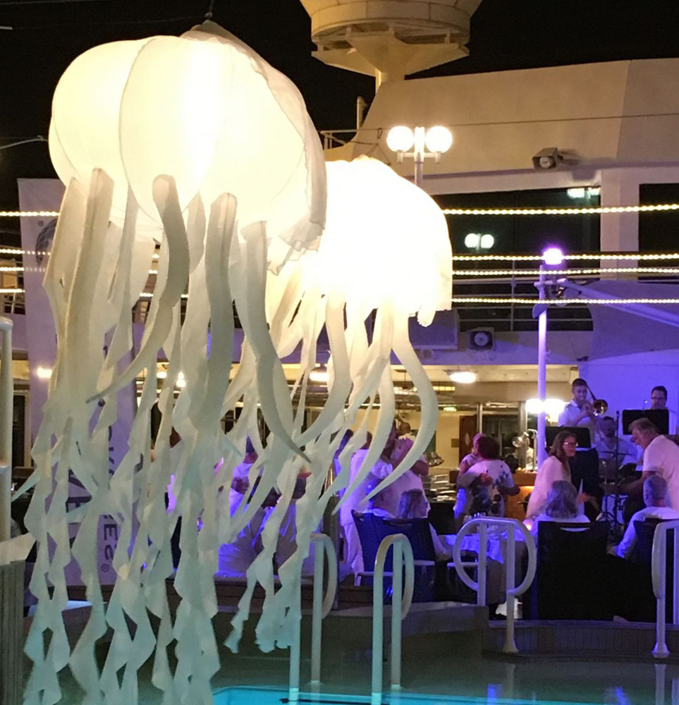 An Azamara cruise ship crew serving guests a delectable feast
