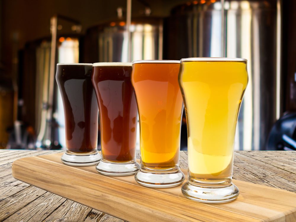 variety of beer options in glasses on bar