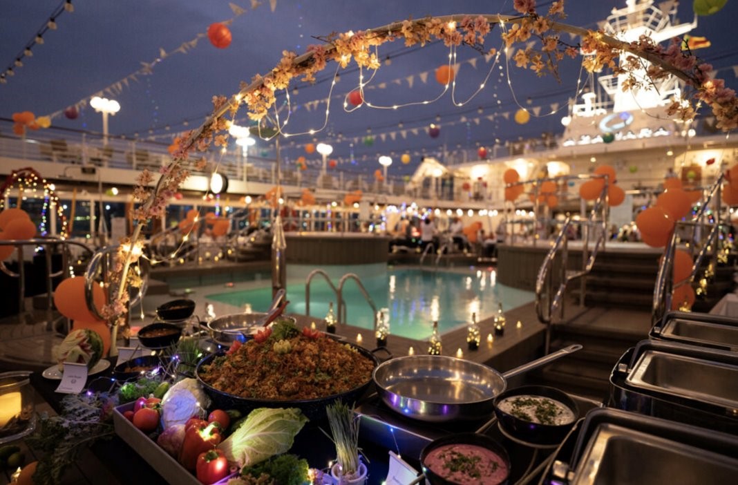 poolside dinner buffet on ship deck at night