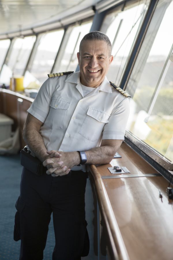 Azamara Ship Captain stands in front of the Sydney Opera House