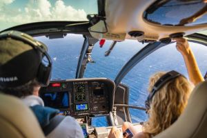 Pilot and female passenger in helicopter cockpit