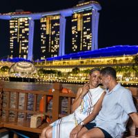 couple sitting waterside in the evening