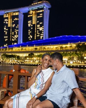 couple sitting waterside in the evening