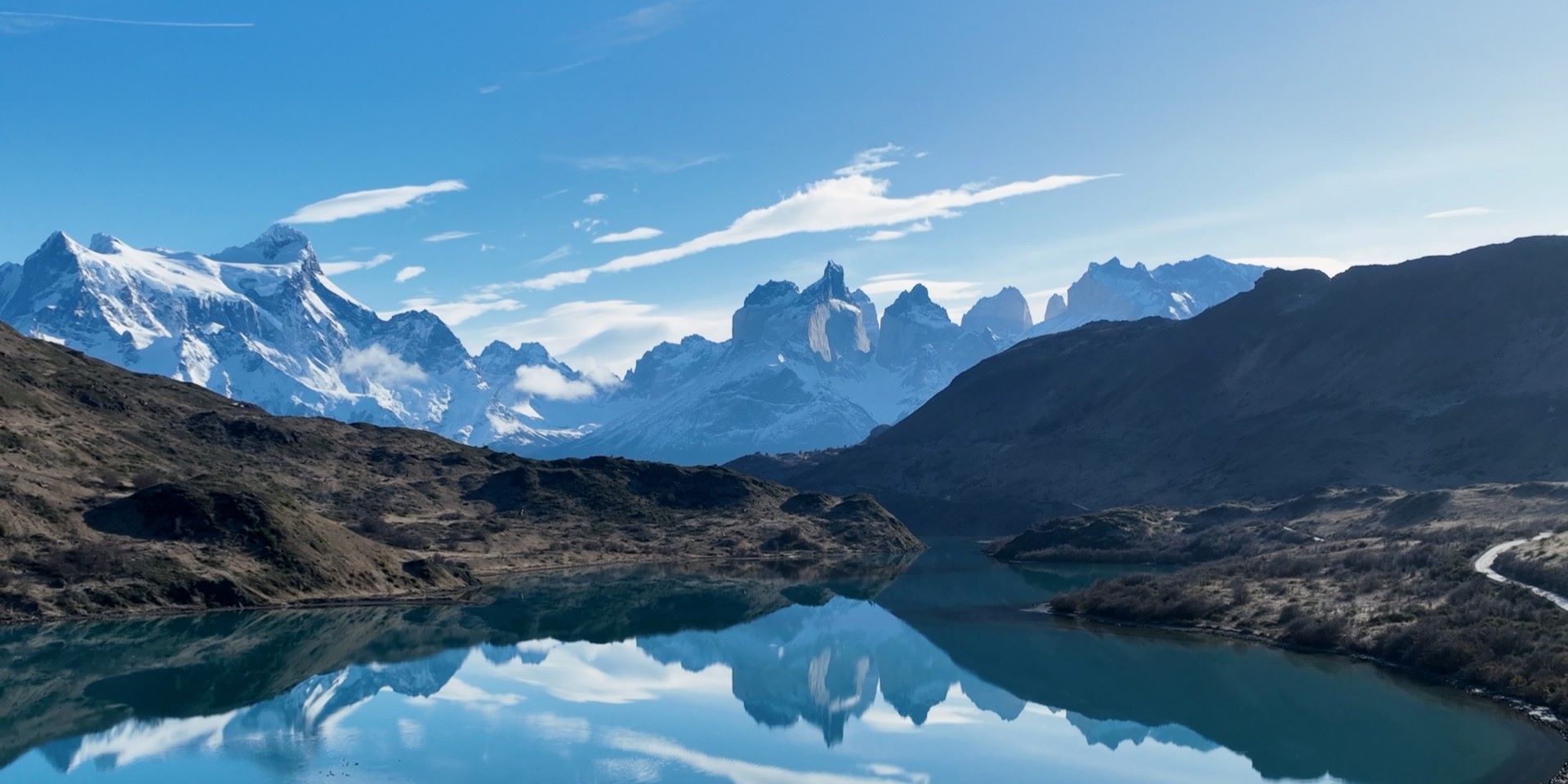 snowcapped mountains overlooking blue lake in valley