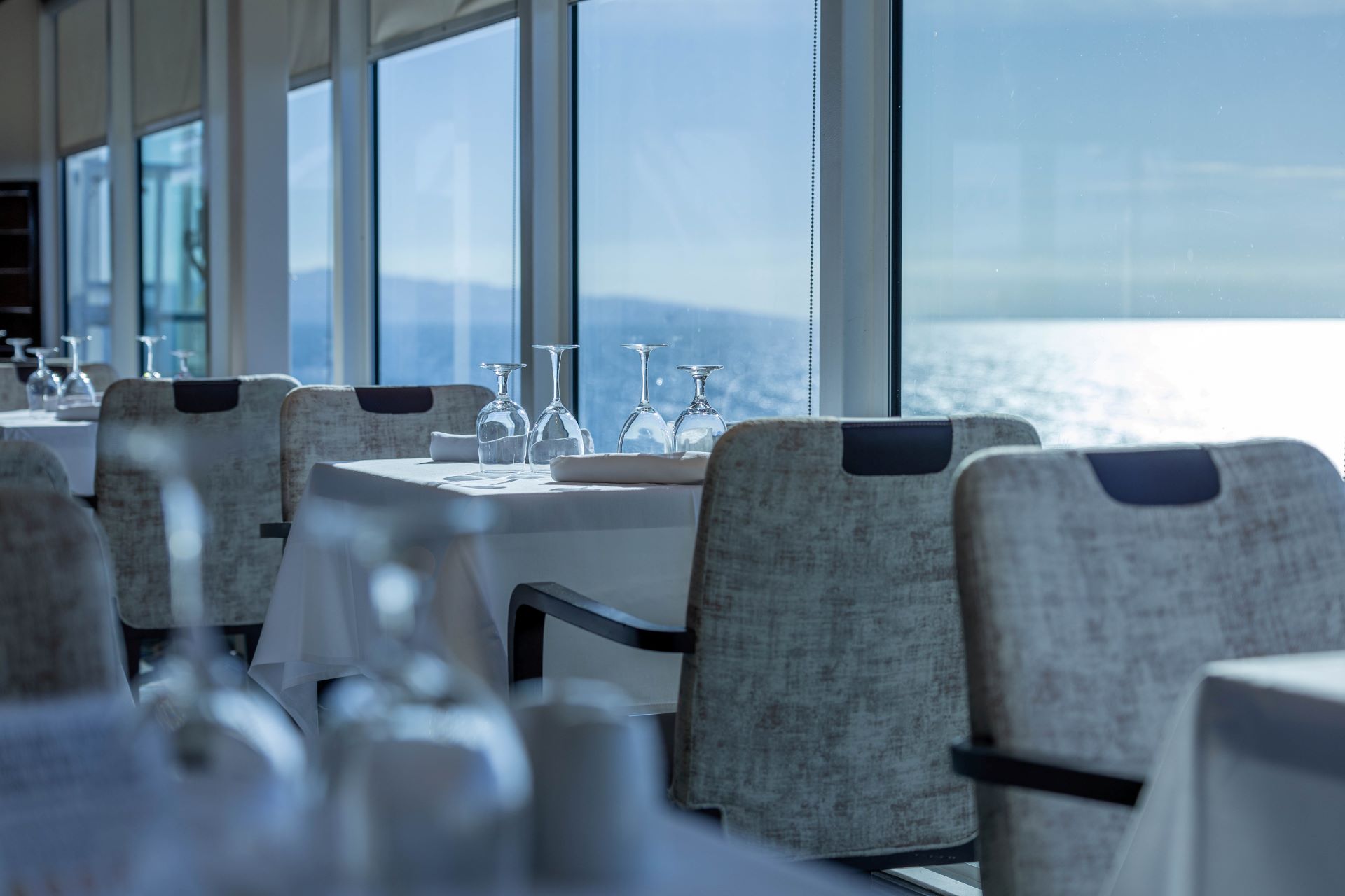 cruise ship dining room overlooking sunlit water